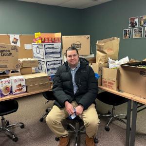 Lee Emmons, drive coordinator, takes a break from sorting donations for the Snacks for Students drive. Courtesy photo
