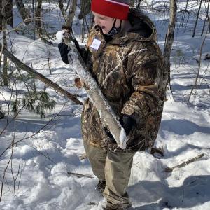 Corbin Bryer finds wood for a shelter. Courtesy of Becky Hallowell