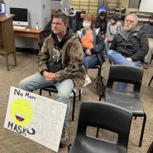 Wiscasset resident Doug Wyman attends the school committee’s March 8 meeting with a sign in hopes of encouraging board members to adopt the Center for Disease Control’s optional mask protocol. BILL PEARSON/Boothbay Register