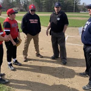 Umpire Ed Crocker held a pre-game conference May 7 with Wiscasset coach Phil DeVice and his team captains Pete Rego, left, and Noah Ruzyckis along with Boothbay Region coach Dennis Dacus prior to the first game between the two schools in four years. BILL PEARSON/Boothbay Register