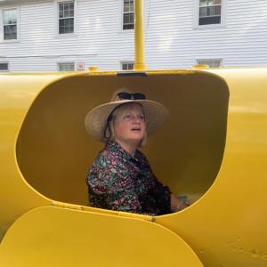 Newcastle’s Adrianne Zahner tries out a yellow submarine of sound at the June 30 Wiscasset Art Walk. SUSAN JOHNS/Wiscasset Newspaper