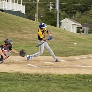 Finn Harkins from Boothbay hits the ball to center field
during a game against Lisbon. Courtesy of Shanon Cotta