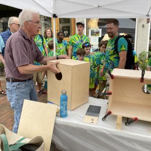 During July’s Wiscasset Art Walk, Rick Burns of Wiscasset makes cajóns while a group of Houston campers stops by to watch. Wiscasset Art Walk photo