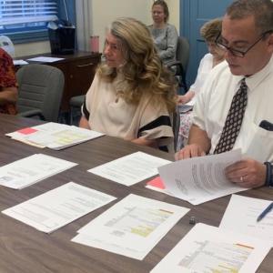 Chief Deputy Rand Maker, right, and Executive Director Elizabeth Simoni, center, of Maine Pretrial Services explained factors behind a 27.9% increase in services for individuals involved in the court system during the Aug. 2 commissioners’ meeting. BILL PEARSON/Boothbay Register