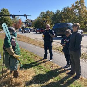 Wiscasset Police Chief Larry Hesseltine left, stands back with Leslie Hunter and Mary Beth Brandt to admire their entry in the scarecrow contest. EDNA MILLER/Wiscasset Newspaper