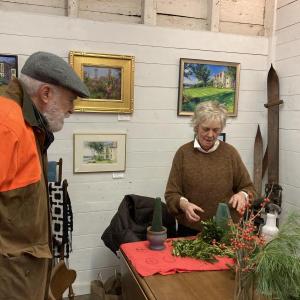Mare LeMay explains the process of building a tree to Michael Olszewski of Wiscasset. EDNA MILLER/Wiscasset Newspaper