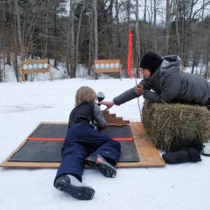 Coaching a shooter at the paintball range. Courtesy of Midcoast Conservancy