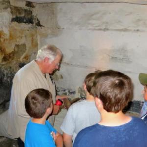 LCHA volunteer docent Greg Shaw tells a group of students about life in the Old Lincoln County Jail. Courtesy of LCHA