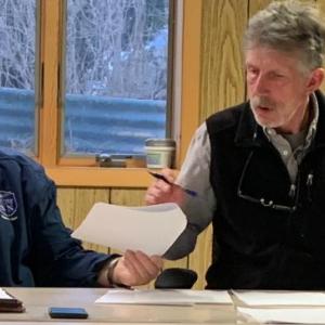 During the April 4 board meeting, selectmen Ted Hugger, left, and Mike Smith review the special town referendum ballot. BILL PEARSON/Boothbay Register