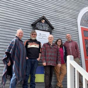 Outside St. Philip’s March 24, from left, are church members Terry Heller and Jon Young, Priest In Charge Tom Junkert and Amistad’s (now commonspace) Meredith Pesce and Brian Townsend. File photo