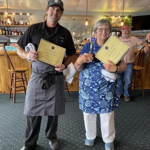 Kelly Farrin, People’s Choice Winner, and Tancy Mitchell, Judge’s Choice Winner, pose with gift certificates. Courtesy of Stephanie Branch