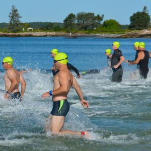 Swimmers enter the water at Pemaquid Beach at the start of the 2019 Pemaquid Beach Triathlon. Courtesy of Coastal Rivers