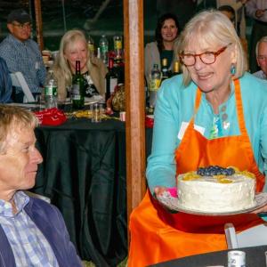 Linda Pope displays a fabulous cake during the auction of desserts at last year’s Preservation Party. Bob Bond photo
