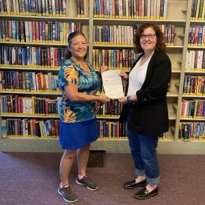 Pamela Dunning, director of Wiscasset Public Library, receives the grant award from Julie Casson, community digital planner, Coastal Maine Regional Broadband. Courtesy photo