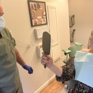 Dr. David Pier of Mount Pleasant Dental Care in West Rockport with Samantha Hunt. Hunt is taking her first look at the smile that Dr. Pier and his staff restored for her for free through “Finding Our Smiles.” Patrisha McLean photo