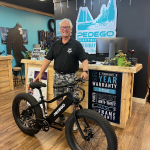 Roger Matthews with a new Pedago electric bike that he and Lisa donated to our live auction. Courtesy photo