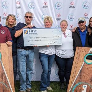 Members of the Boothbay Classic Cornhole team hold a mock check for Special Olympics Maine. CANDI JONETH/Boothbay Register
