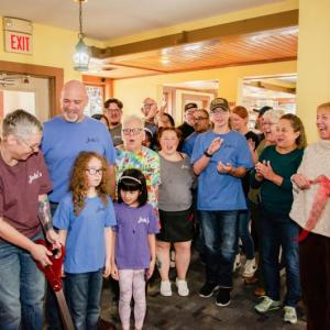 Jodie’s Cafe and Bakery owner Jodie Roquemore and other celebrants cut the ribbon at the restaurant Sept. 30 in the Water Street, Wiscasset building that long housed Sarah’s Cafe. Bob Bond photo/40 Federal Studio