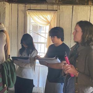 WMHS high school students Ruth Burchstead, Jhered Loyola and Tiffany Loyola study the woolen wheels at the 1754 Chapman-Hall House. Courtesy photo