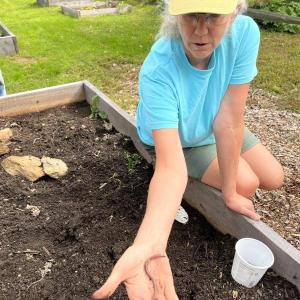Laurie Burhoe, KELT Garden coordinator, with a Jumping worm. Courtesy of KELT