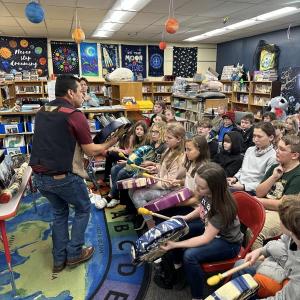 Nova Sherman, Trinity Nelson, Alice Puterbaugh, Amesley Franssen, and Shelby Suplinskas sit in the front row practicing their animal hide drums, led by Dwayne Tomah. Courtesy photo