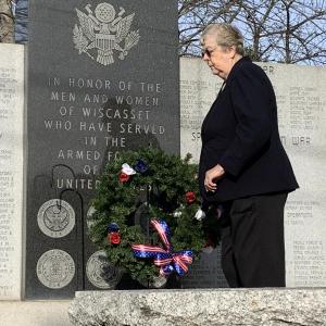 Auxiliary President Diane Munsey lays a wreath at the Honor Wall in Wiscasset during American Legion Post 54’s Veterans Day service last year. File photo