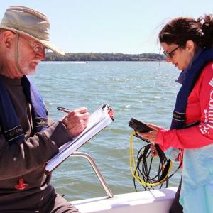 Coastal Rivers Conservation Trust volunteers use a sonde device to collect water quality data in the Damariscotta River estuary. Courtesy of Kris Christine