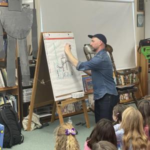 New York Times best-selling author Peter Brown personalizes a sketch for CTL students. Courtesy photo