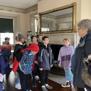 Merry McDonnell tells stories of Nickels-Sortwell House to the fourth grade students. Becky Hallowell photo