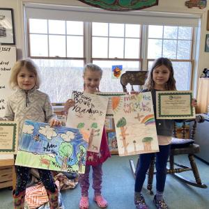 From left, Quinn Gallagher, Finley Barnes-Vieten and Elena Vito present share their award-winning posters at morning meeting. Courtesy of CTL
