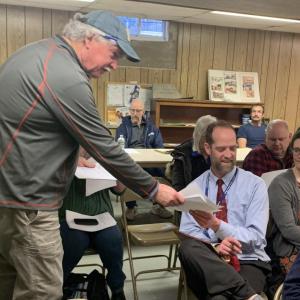 Budget Committee Chairman Jack Brennan hands out a worksheet March 20 prior to Edgecomb’s informational hearing. BILL PEARSON/Boothbay Register