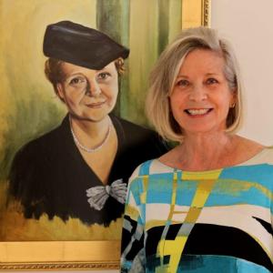 Artist and first time author Ruth Monsell standing in front of her portrait of Frances Perkins displayed in the Frances Perkins Center in Newcastle. Courtesy of Ruth Monsell