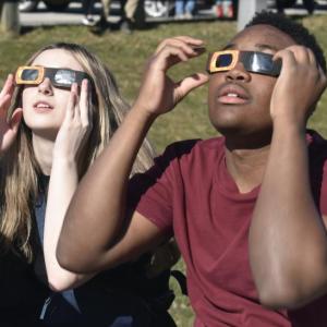 Katelyn Lahaye and Javar Garricks were excited to witness the awe-inspiring eclipse Monday afternoon. They and many of their Wiscasset Middle High School classmates gathered in the school’s parking lot to watch the rare event. Partners in Education (PIE) sponsored a watch party offering snacks and drinks. PHIL DI VECE/Wiscasset Newspaper