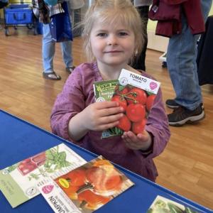 A visitor picks up some seed packets at a past Healthy Kids Day. Courtesy of Veggies to Table.