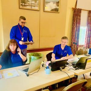 Customer Service Representatives (CSRs), from left, Daphne Reeve, Frank Irizarry and Anthony Martinez Jimenez, prepare to assist survivors at the Willing Worker's Hall in New Harbor. Courtesy photo