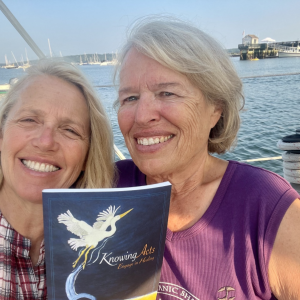 Patrisha McLean, left, with Heidi Love who joins the online discussion of her new book “Laughing at the Sky.” The book Love holds is a healing workbook FOV distributes as a peer-support gift to Maine women survivors of domestic abuse. Finding Our Voices photo