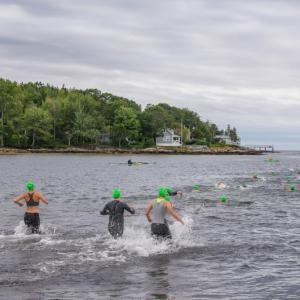 Swimmers enter the water at Pemaquid Beach during the 2023 triathlon. Courtesy of Bob Kofman