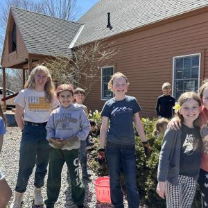 CTL students from kindergarten through fifth grade plant flowers in garden beds at the front of the school. Courtesy of CTL