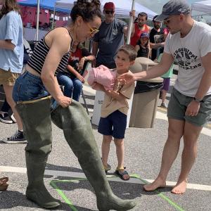 Wiscasset’s Corbin and Lucy Flores-Lichtinger and son Gideon, 7, take part in a relay at Wormfest in Wiscasset June 8. SUSAN JOHNS/Wiscasset Newspaper