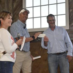 Boothbay Harbor Chamber board member Julie Roberts presents a check for the Fishermen’s Memorial Fund. Accepting on behalf of FMF is Corey Pottle. LISA KRISTOFF/Boothbay Register