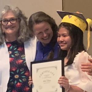 Fifth grade teacher Dr. Katharine Race and sixth grade teacher Laurie Brown presented Ariel Doan The Academic Award at the June 14 graduation ceremony. BILL PEARSON/Boothbay Register