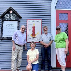 From left, Fundraising Committee Chair Richard Malaby and some of the committee’s members, Sharman Ballantine, Jon Young and Gretchen Burleigh-Johnson. On the building is a symbolic burning candle created by Mat O'Donnell and Seaver Leslie to illustrate funds raised. Marcie Patton photo