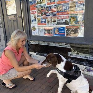 Philo, candidate for king of Wiscasset, offers a paw Aug. 30 to Laurie Winslow, a friend of his owner Cynthia Pappas. SUSAN JOHNS/Wiscasset Newspaper
