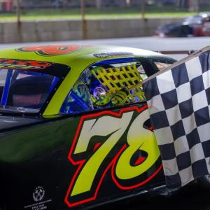 Tiger Colby collects the checkered flag after winning the Late Model 75 at Wiscasset Speedway. Jasen Dickey Photography