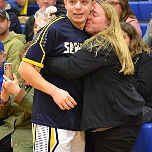 Seahawk senior Dominick Dow gets a kiss from his mother, Emily Dow, during Senior Night. KEVIN BURNHAM/Boothbay Register