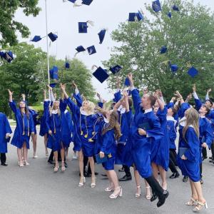 The BRHS Class of 2024 tosses their caps after the graduation ceremony. KEVIN BURNHAM/Boothbay Register
