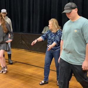 In Stover Auditorium during marching practice May 31, Debra Pooler shows seniors where to be. SUSAN JOHNS/Wiscasset Newspaper 