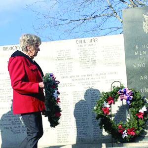 Sandra Winters of American Legion Post 54’s Auxiliary Unit places a wreath at the veterans wall in Wiscasset during Veterans Day ceremonies Nov. 11. SUSAN JOHNS/Wiscasset Newspaper 