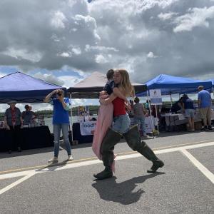 Emmalyn Tarrance, 13, carries brother Henry Tarrance, 8, in the Wormfest relay June 8 in Wiscasset. SUSAN JOHNS/Wiscasset Newspaper 