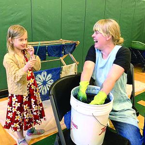 Indigo Sanders-Stoyle, 7, of Wiscasset watches artist Emily Bell-Hoerth dip and dye in indigo at Wiscasset’s Earth Day celebration at Wiscasset Community Center April 27. SUSAN JOHNS/Wiscasset Newspaper 